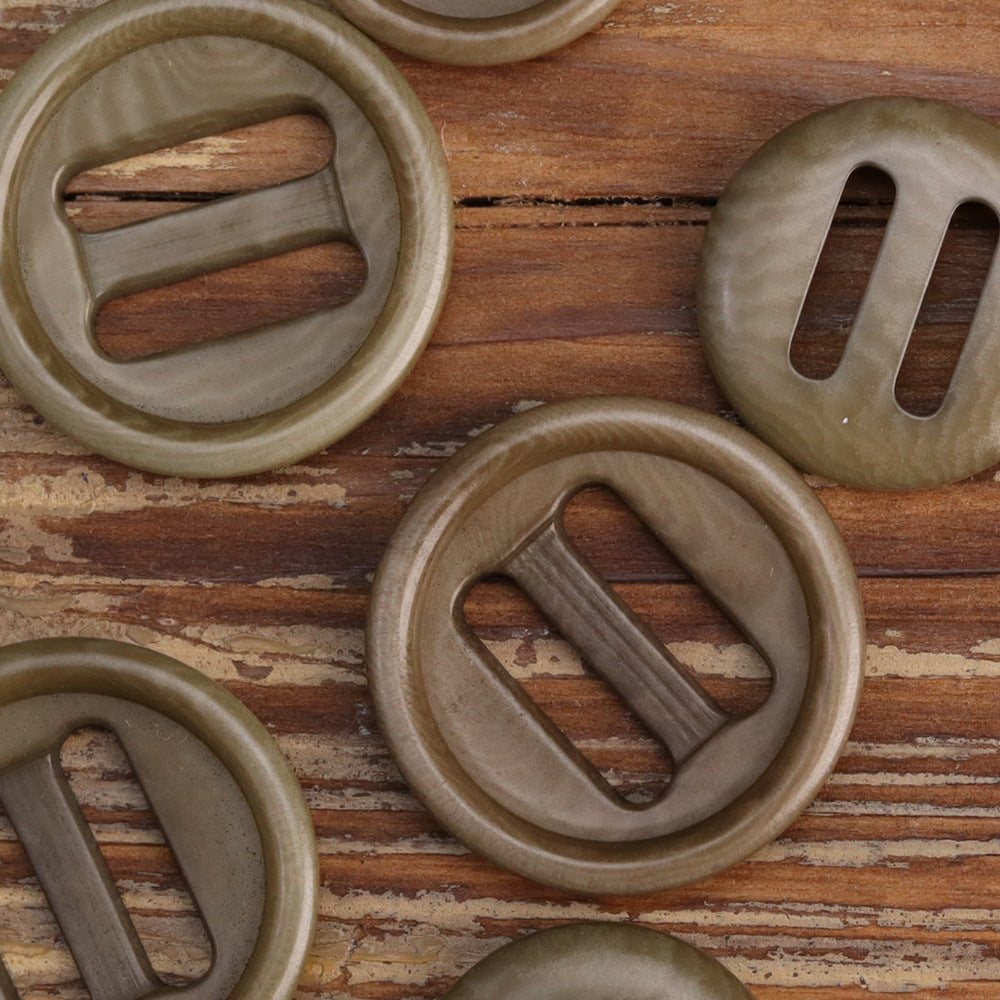 Multiple corozo-style oblong-hole buttons close-up: two taupe shades and one light khaki