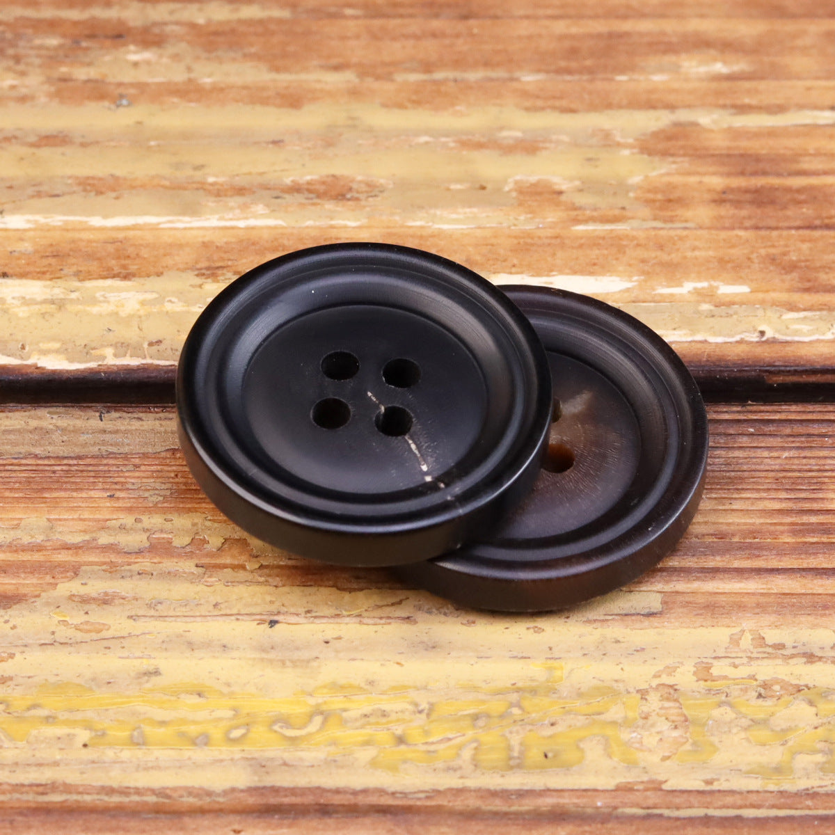 Pair of 15-25mm matte double-circle horn-look buttons with four eyelets
