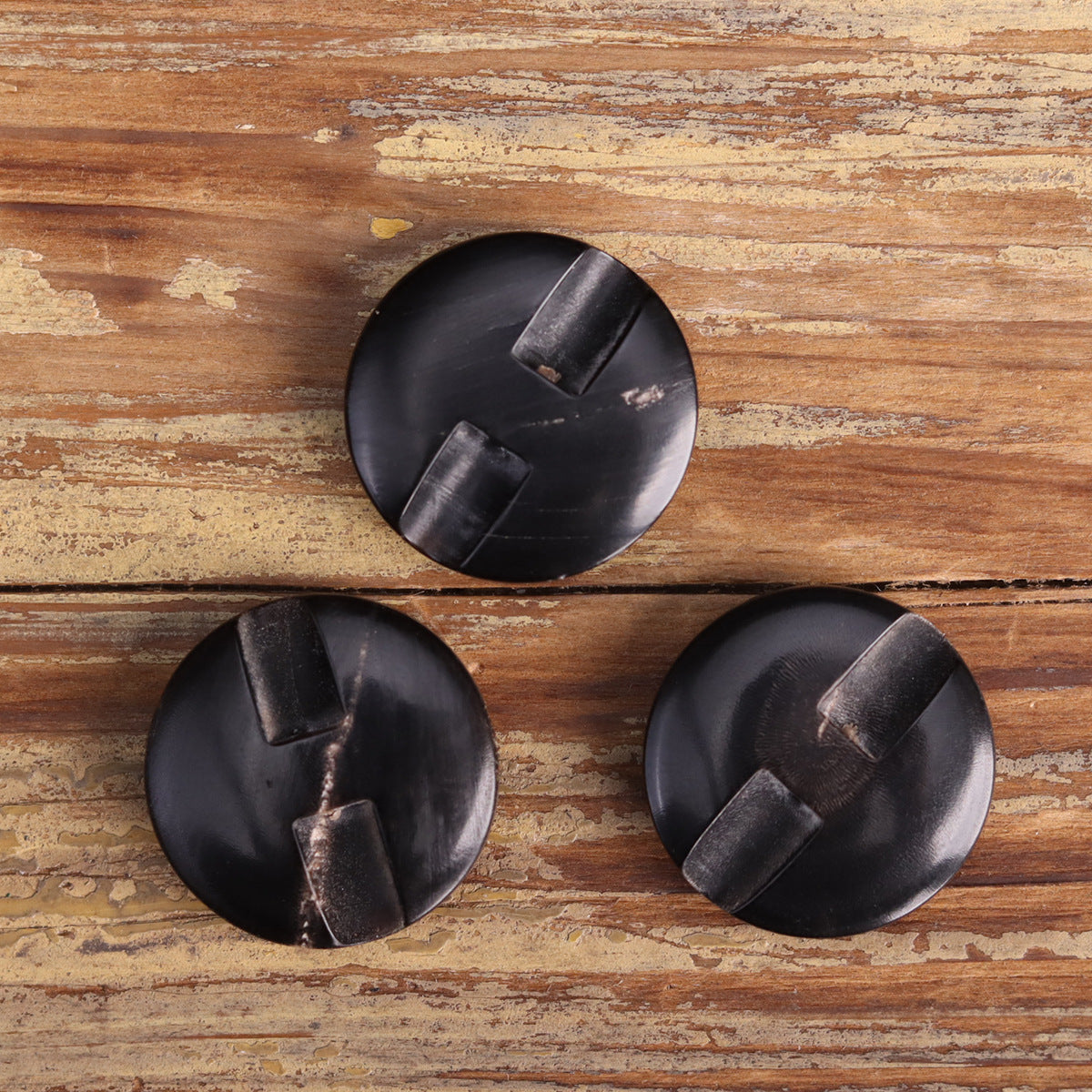 Black genuine horn blind coat buttons with shank backs, flat top view