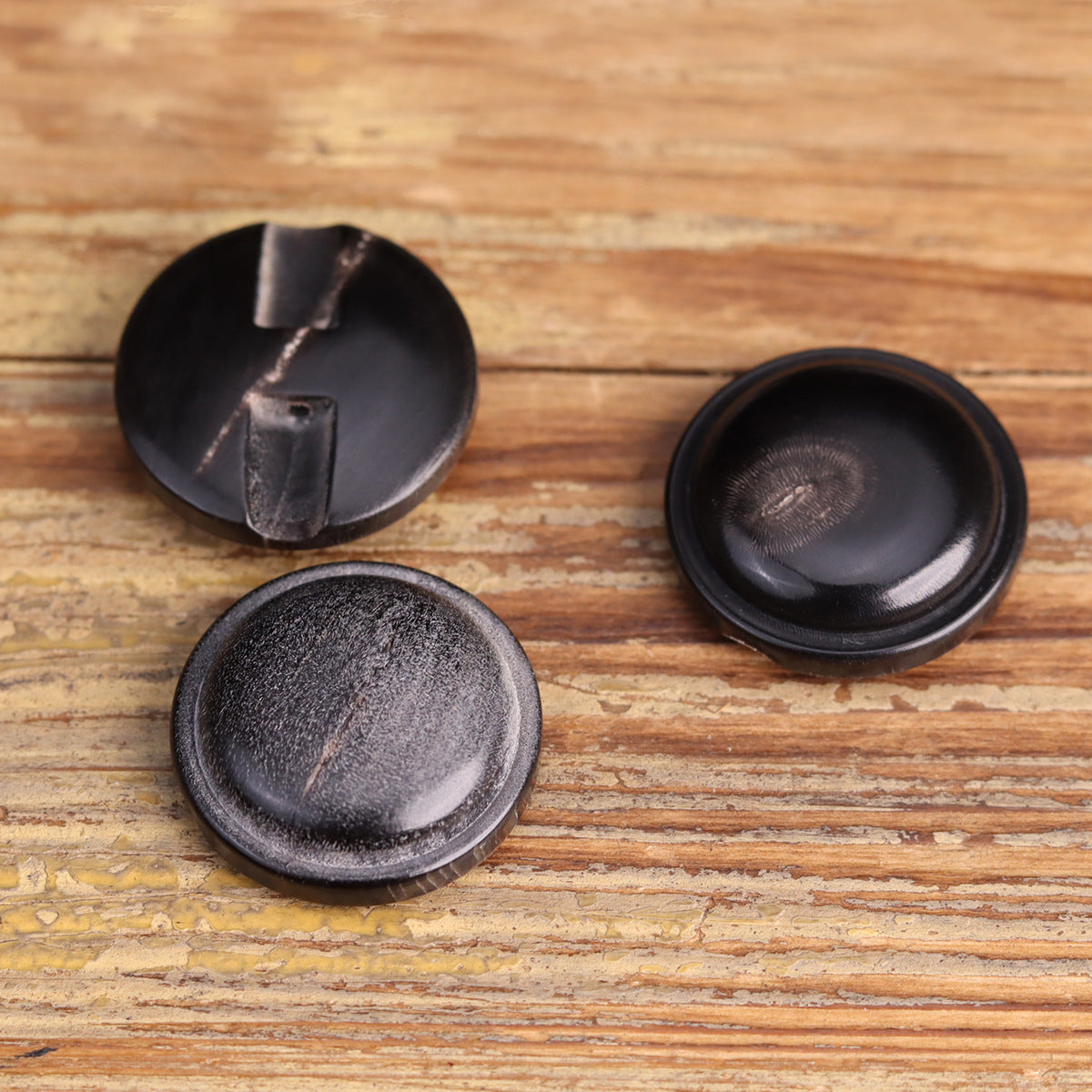 Black genuine horn blind coat buttons, underside with two-slot blind shanks close-up