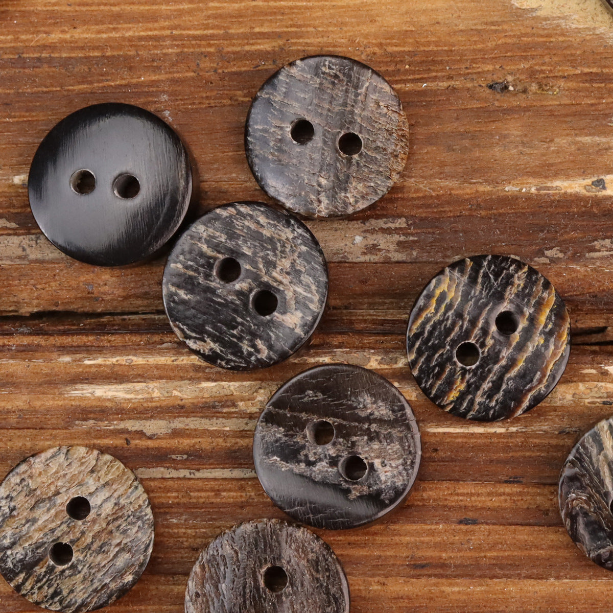 Natural horn-look two-hole buttons, rough dark brown mix with speckled texture and two holes