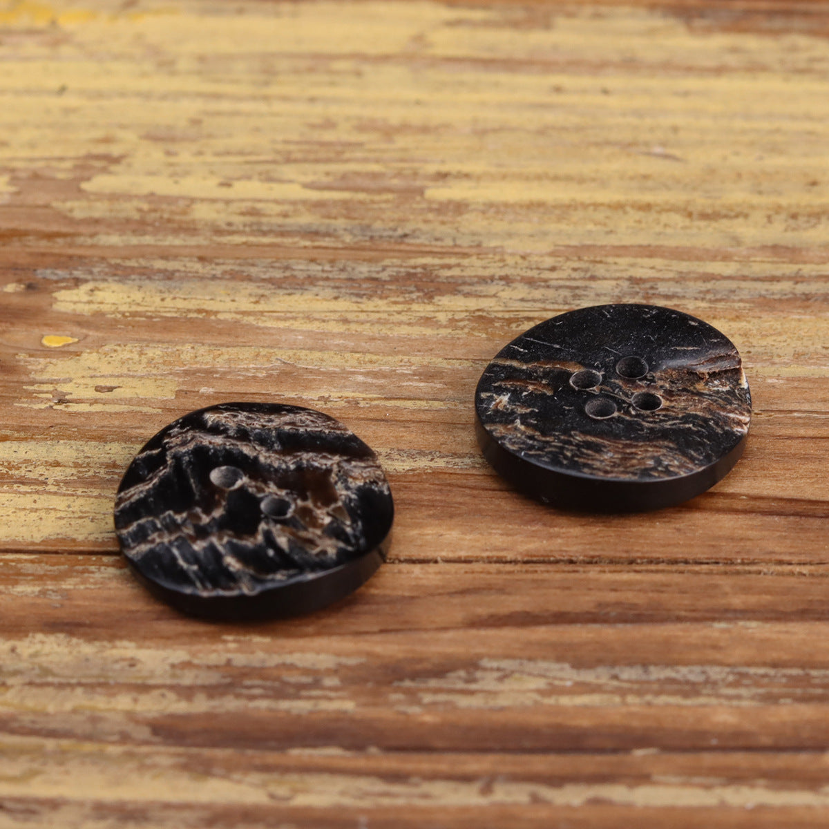 Black rustic flat buttons with textured finish; one 2-hole, one 4-hole