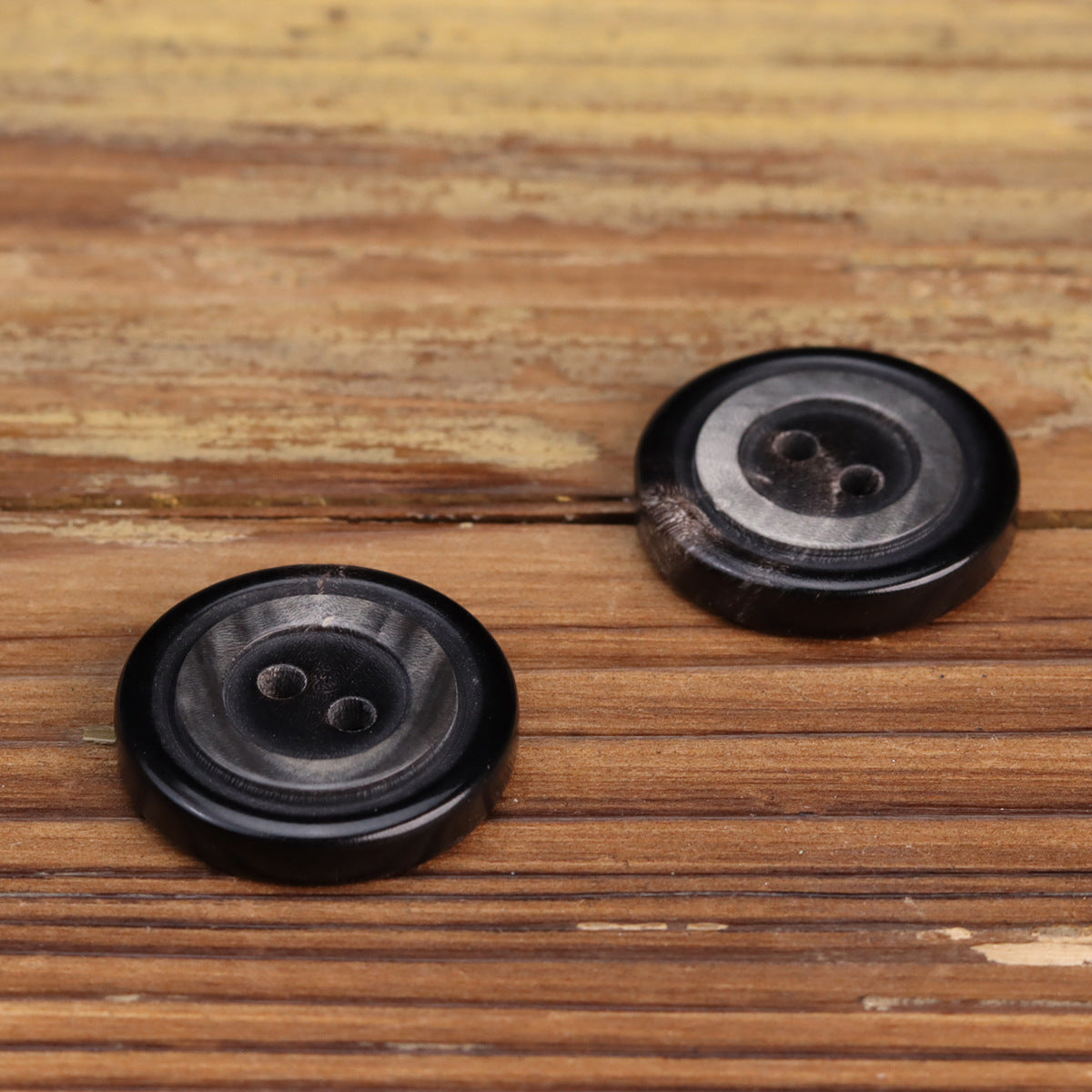 Two-hole water buffalo horn buttons, black, front view pair