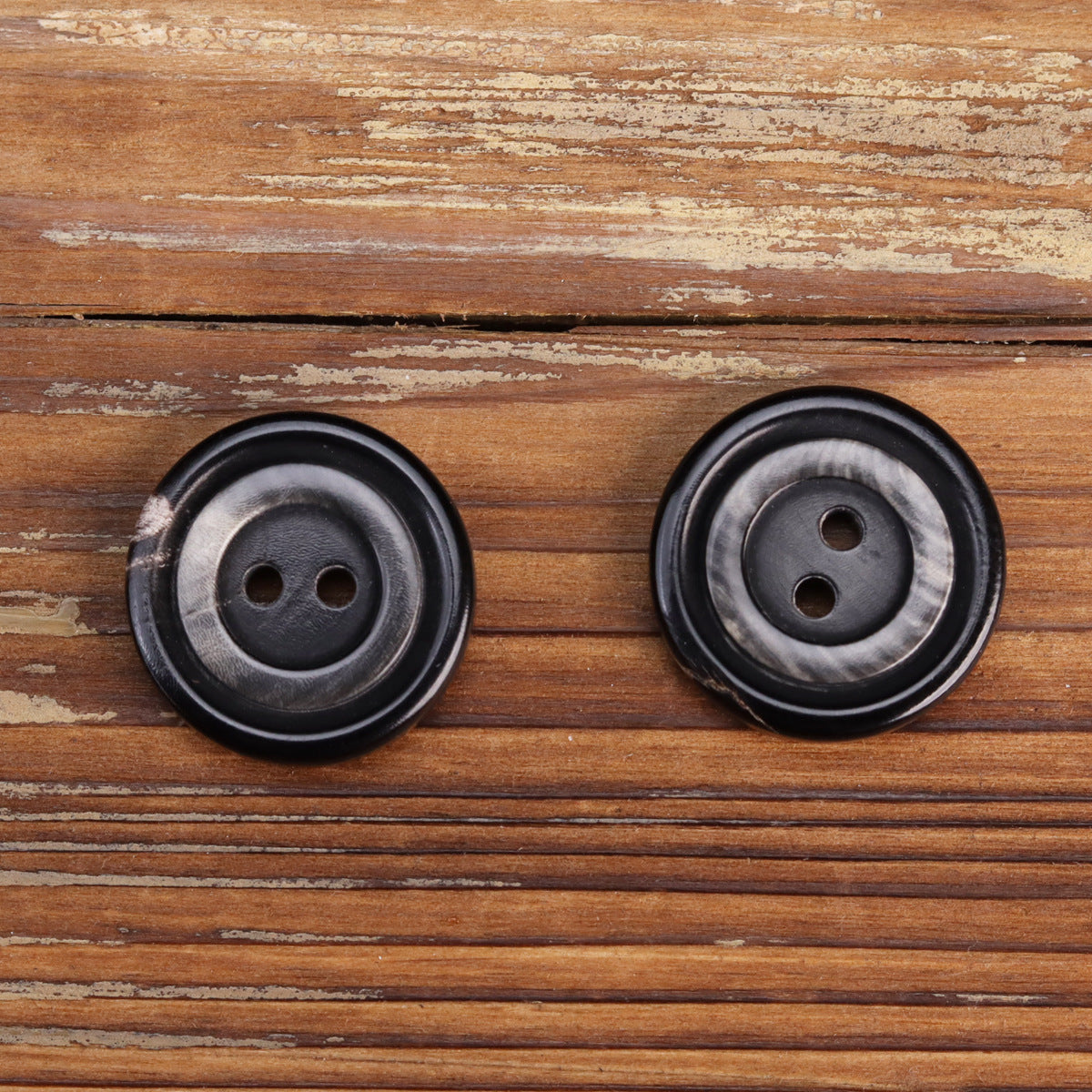 Two-hole water buffalo horn buttons, dark with gray back, reverse view