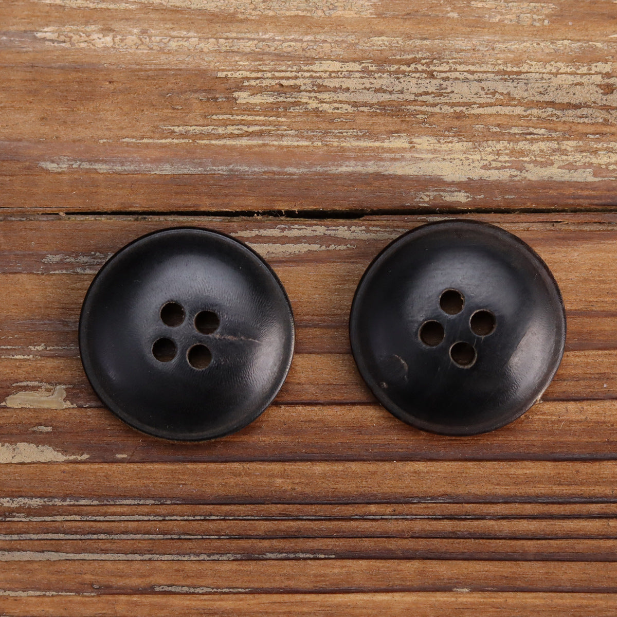 Double-sided black horn buttons, four-hole design (pack of 15)