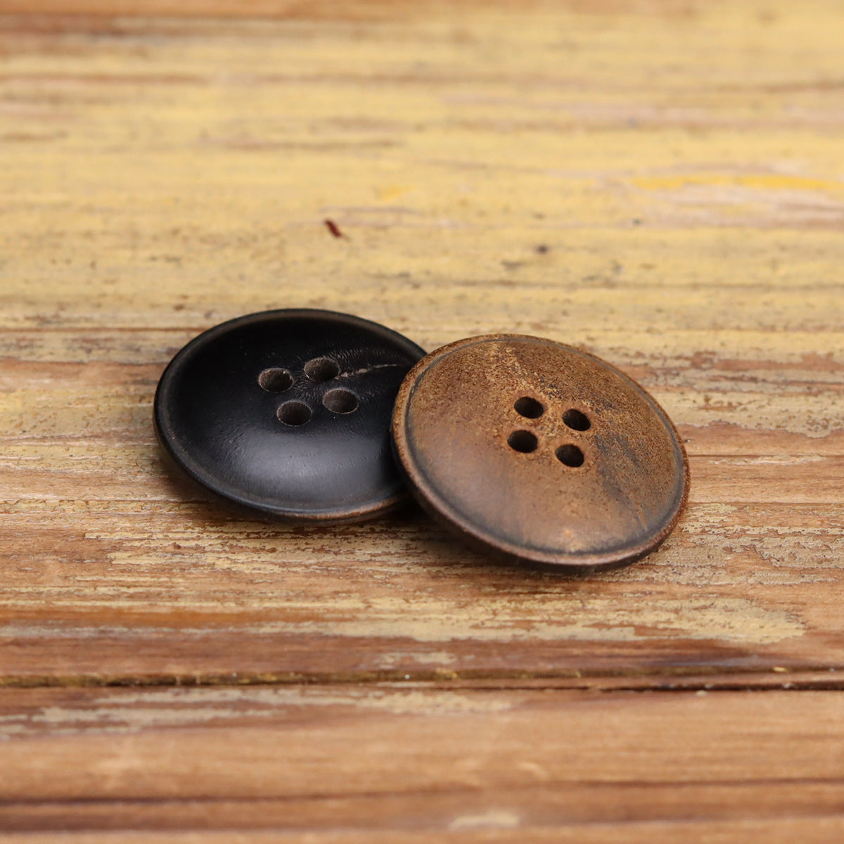 Black and yellowish-brown horn buttons, four-hole front and back mix