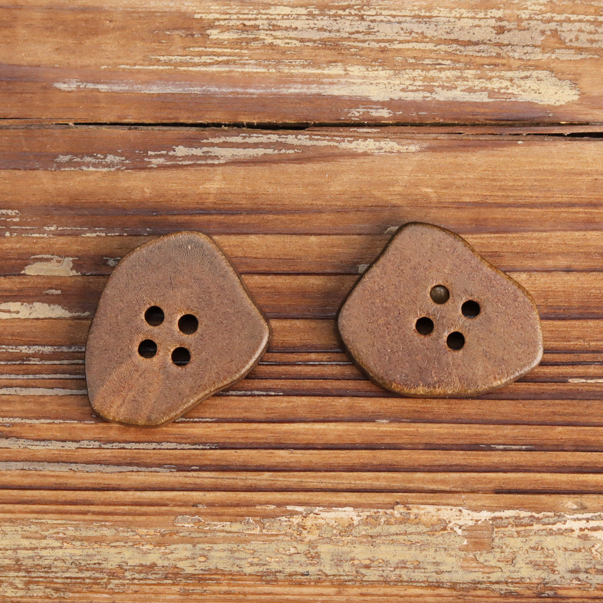 Pair of burnt coffee irregular horn buttons with 4 holes