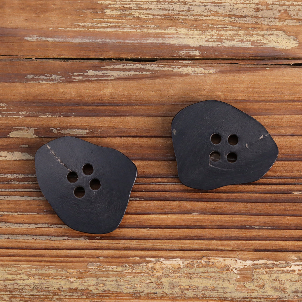 Burnt black irregular horn buttons with 4 holes