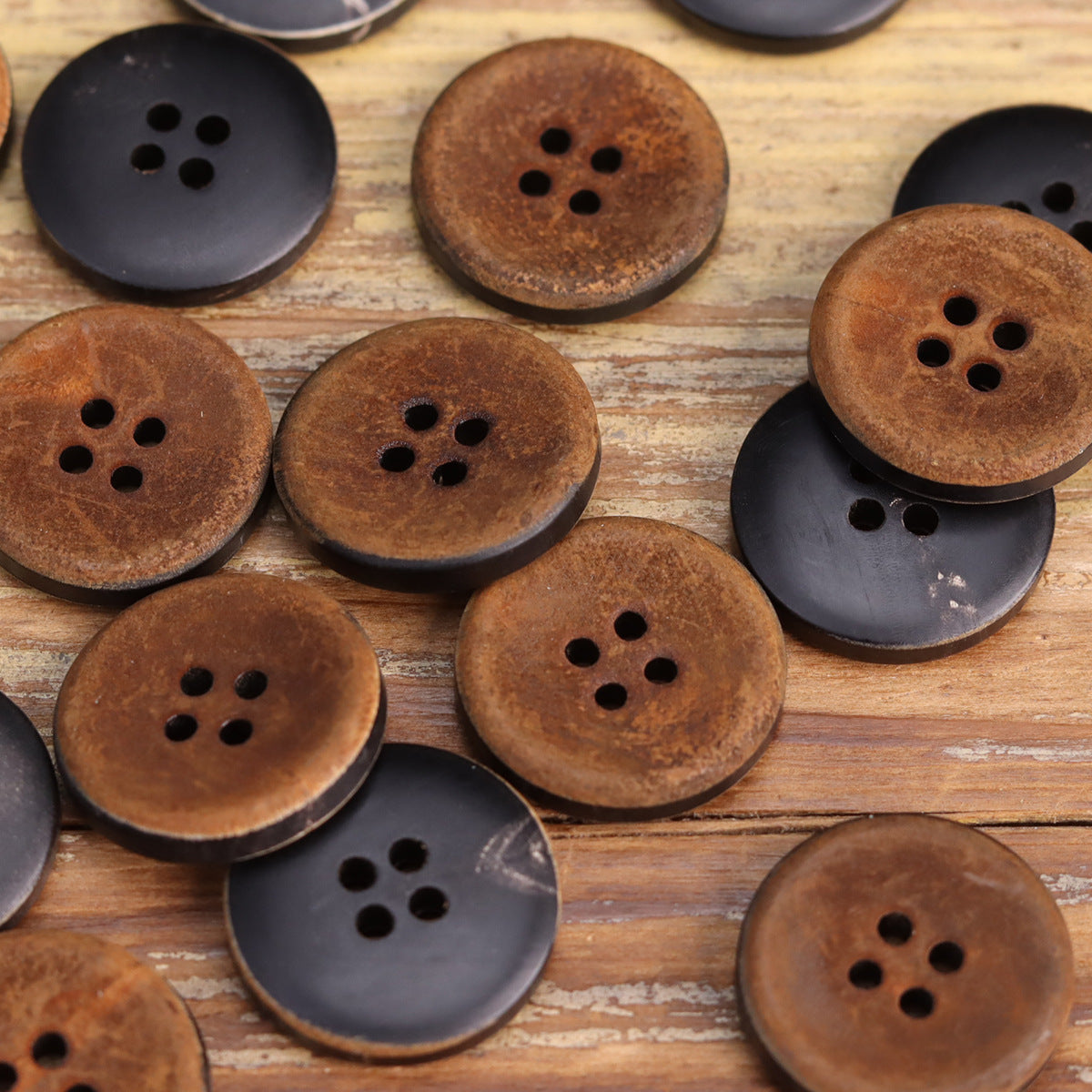 Mixed round buttons: dark red-brown horn with four holes and dark buttons nearby