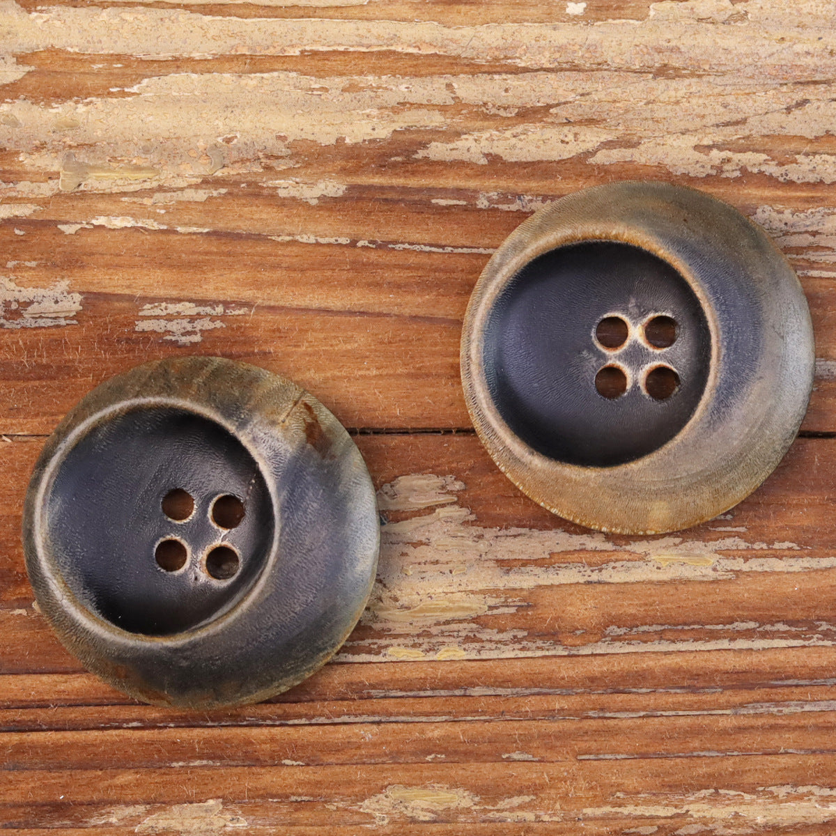 Set of two four-hole buttons, dark center with worn bronze outer border