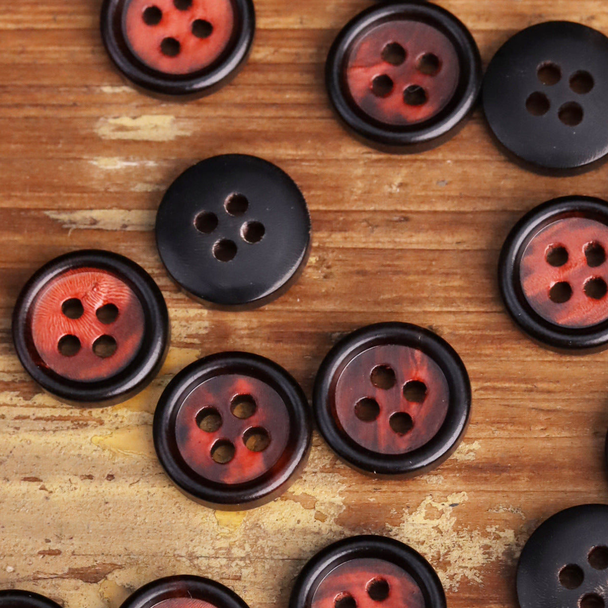 Mixed round shirt buttons with dark rims and red horn-like centers, 4 holes each