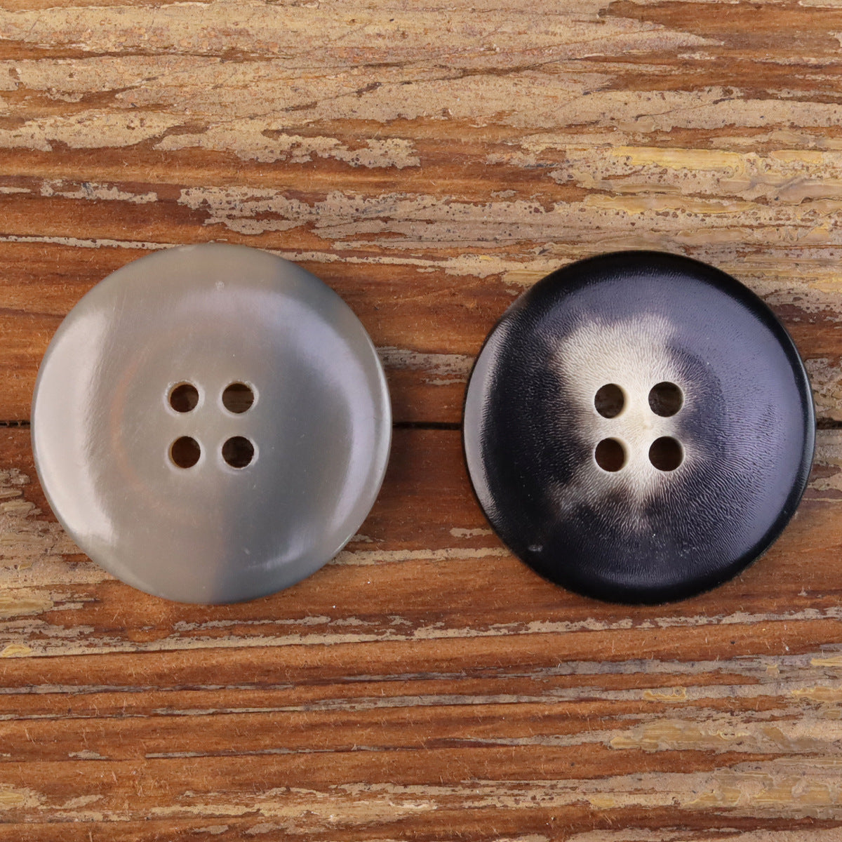 Wide-edged horn-look buttons, 2pcs: beige and black fronts, each with 4 holes