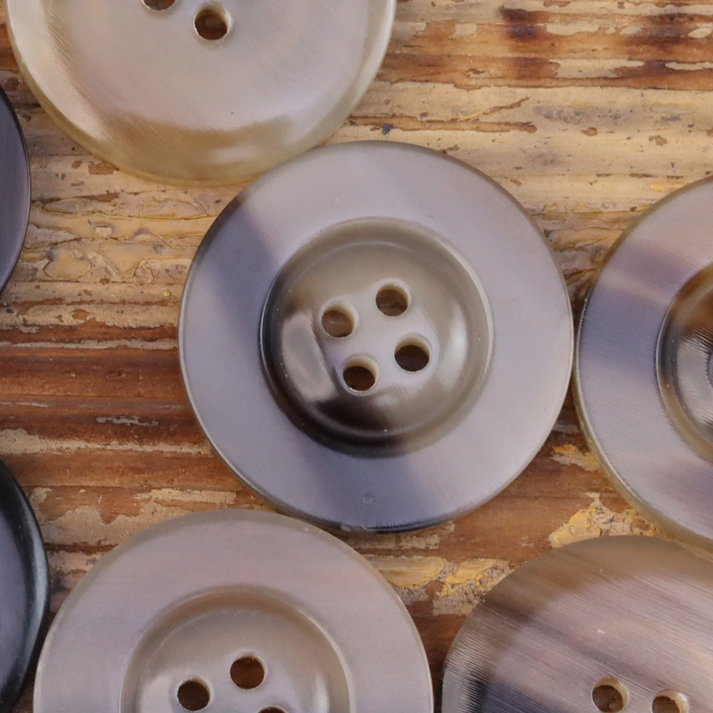 Beige horn-look button with wide edge, 4-hole front and darker inner rim detail