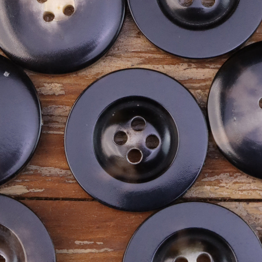 Black horn-look button with wide edge, 4-hole front, satin sheen and dark rim detail