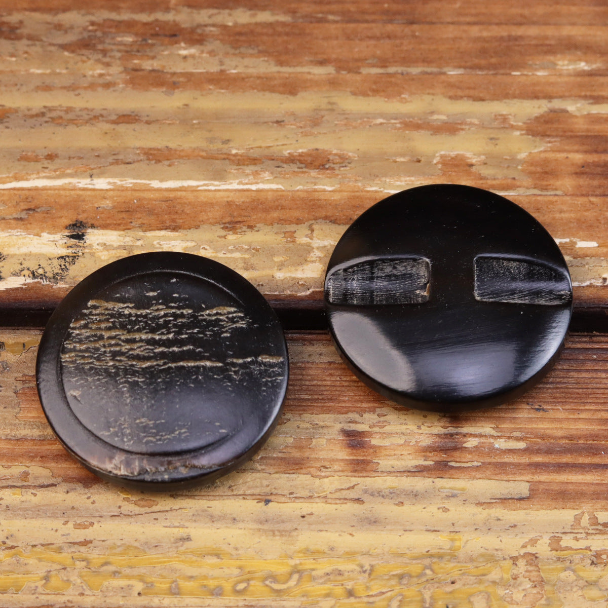 Pair of round coat buttons, faux horn bark texture, dark blue-black with raised center
