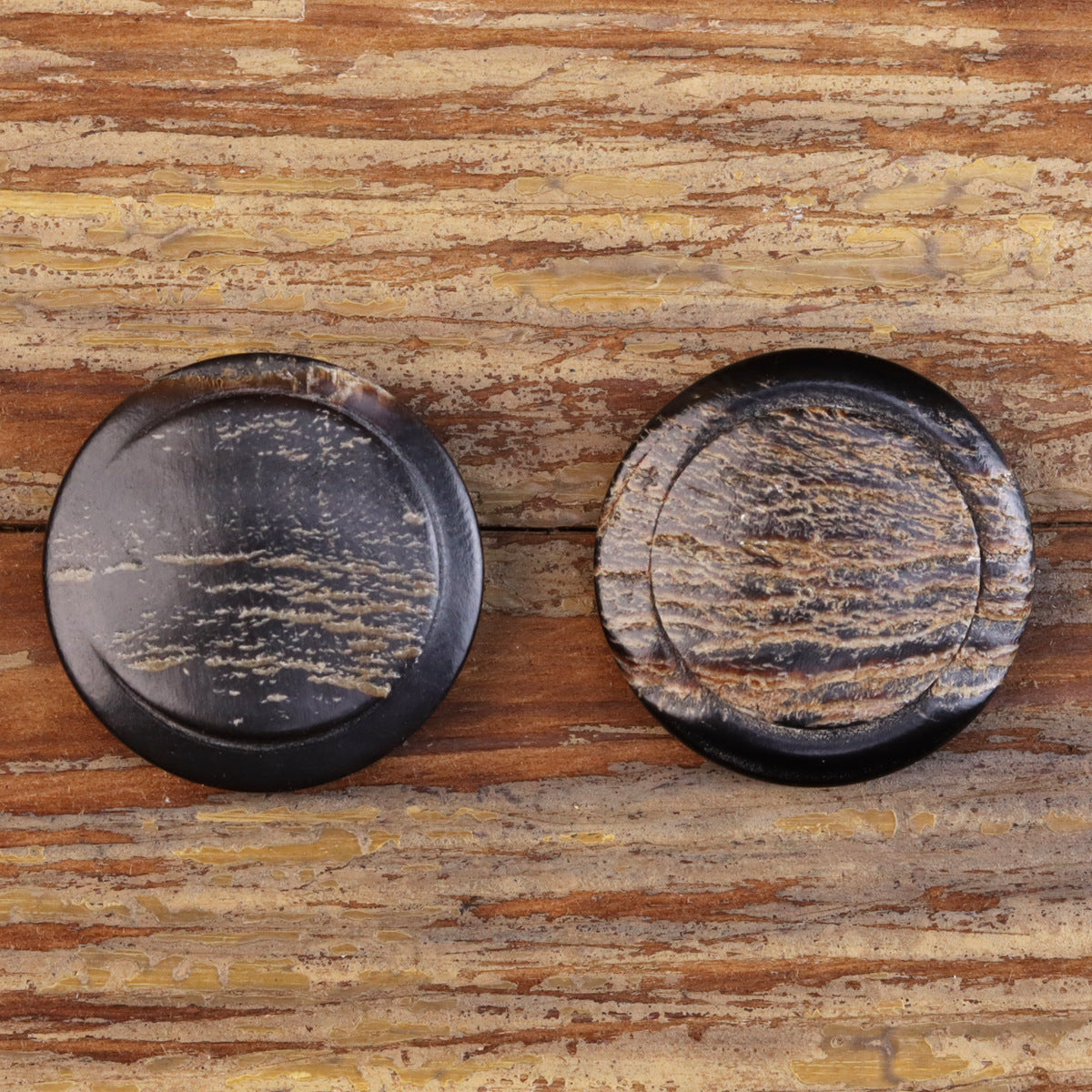 Two 25MM faux horn coat buttons with bark-grain pattern in dark blue-gray