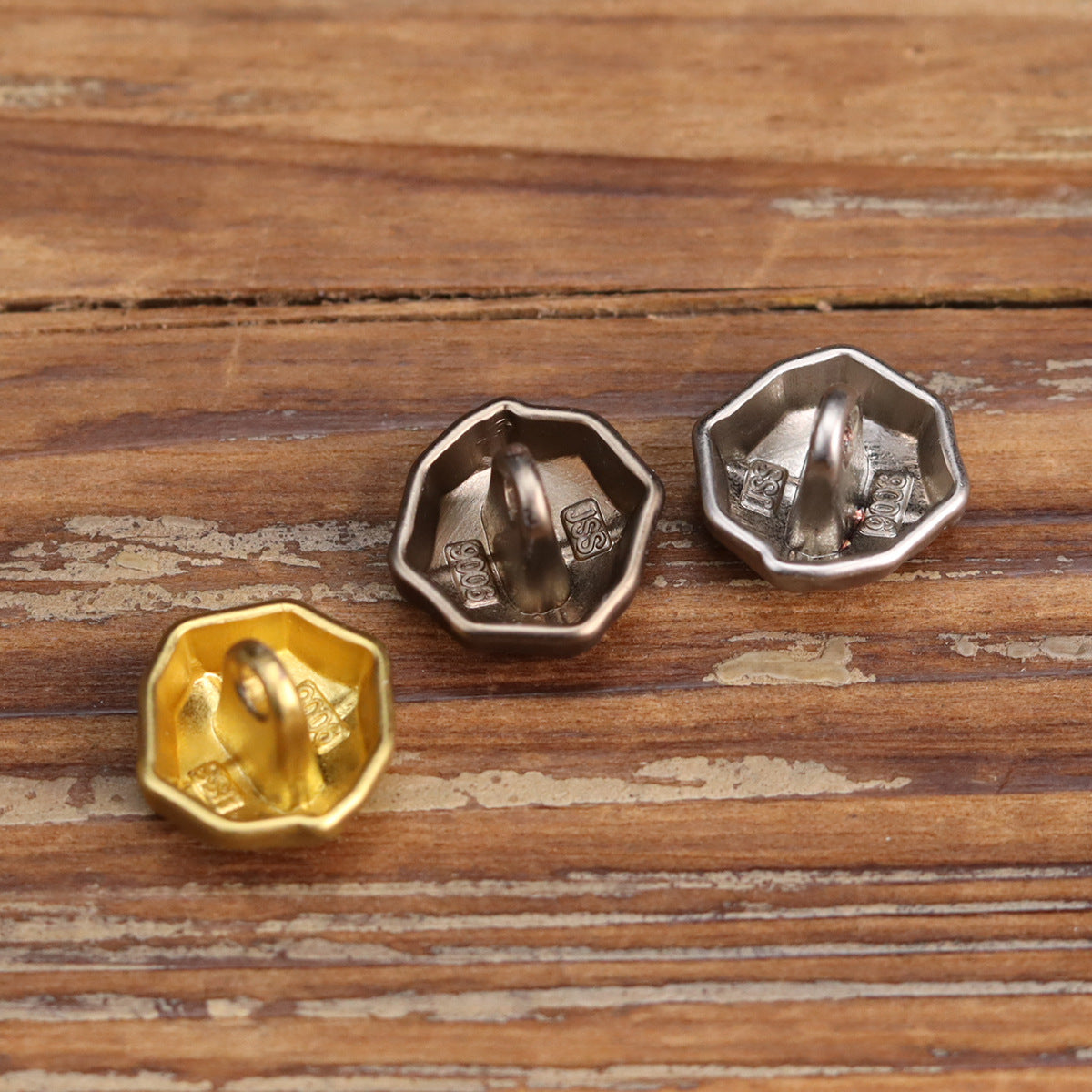 Hexagonal metal button backs and fronts with distressed finish; silver and gold colors