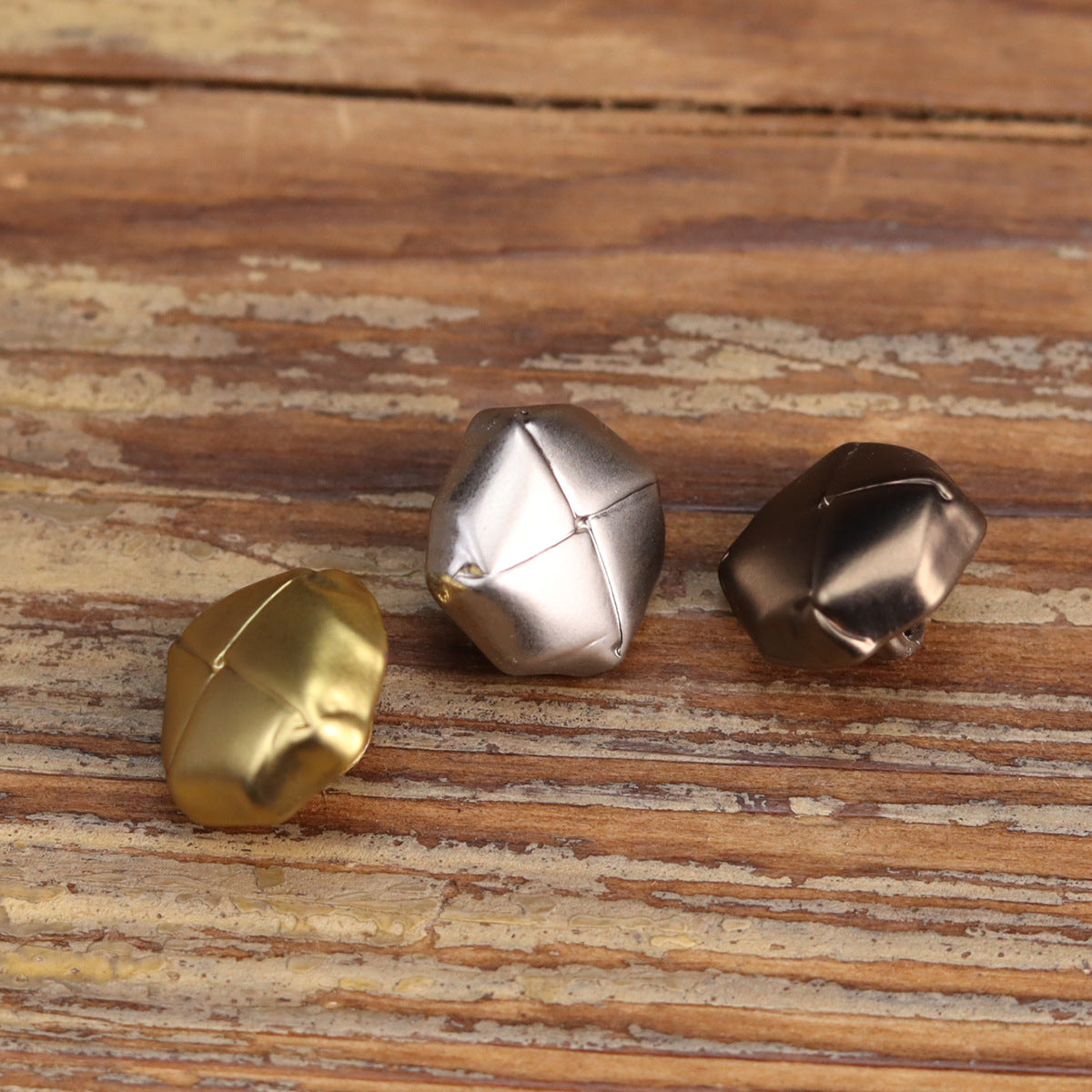 Metal shirt buttons with octagonal face segments; silver, gold, and dark bronze tones