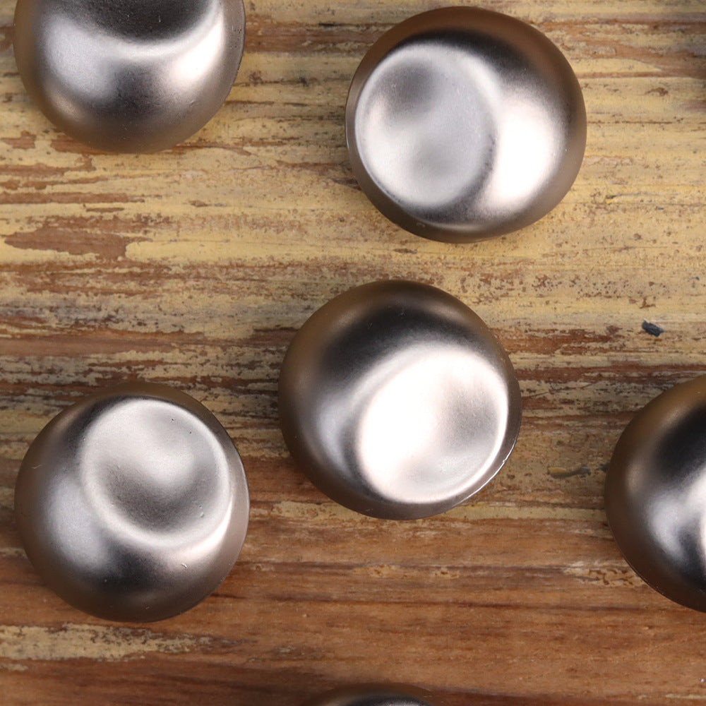 Multiple silver-colored vintage metal buttons, domed front faces (partial set)