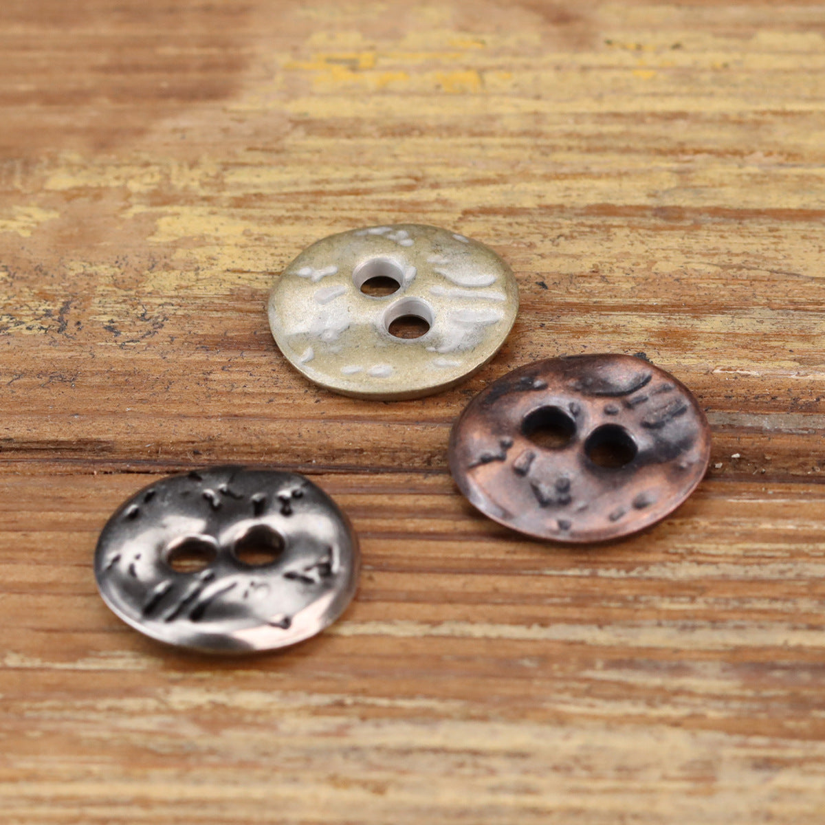 Irregular textured two-hole buttons in cyan tin and red bronze