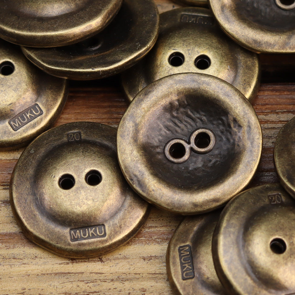 Two-hole metal button, bronze antiqued finish with stamped markings