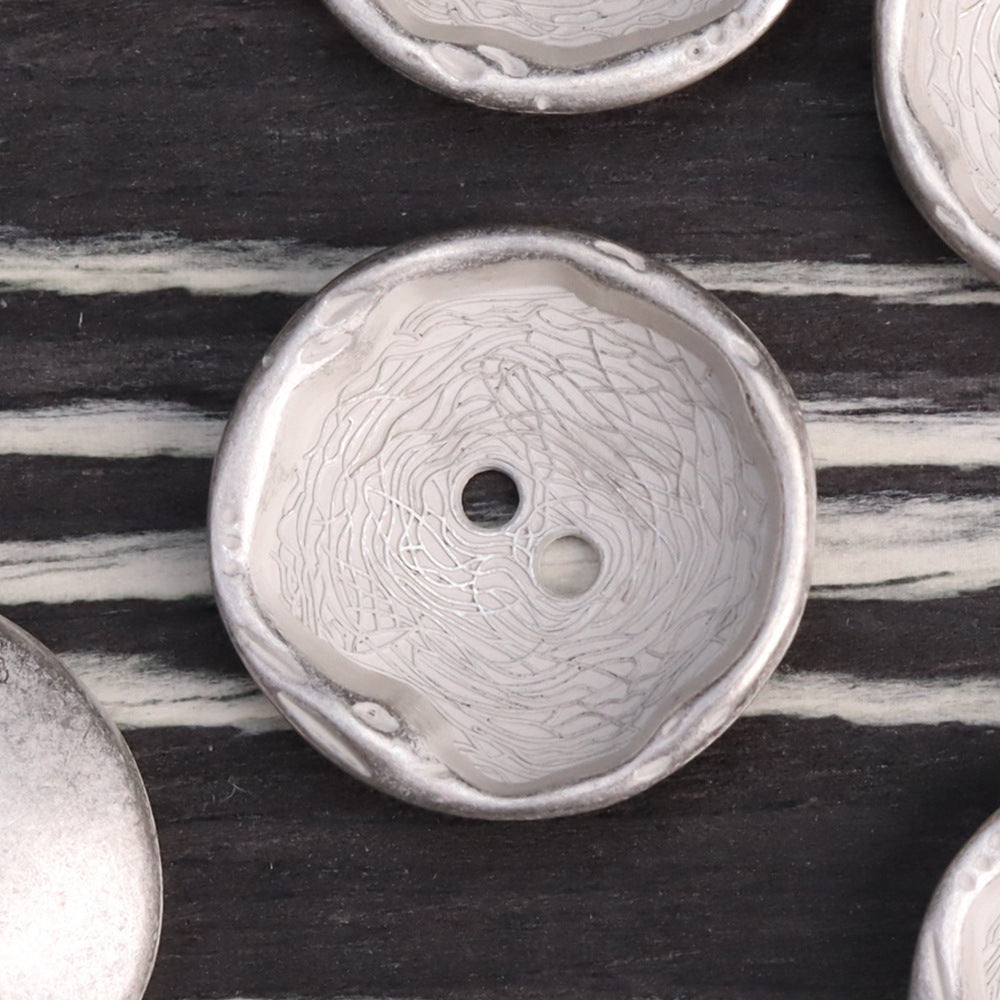 Antique silver 2-hole metal button with embossed swirls