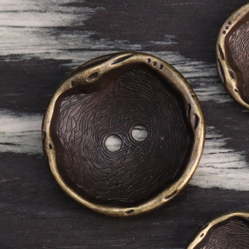 Antique bronze 2-hole metal button with embossed swirl pattern