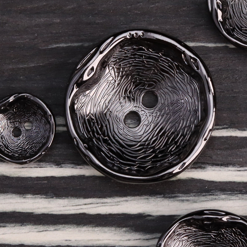 Antique black 2-hole metal button with embossed swirls