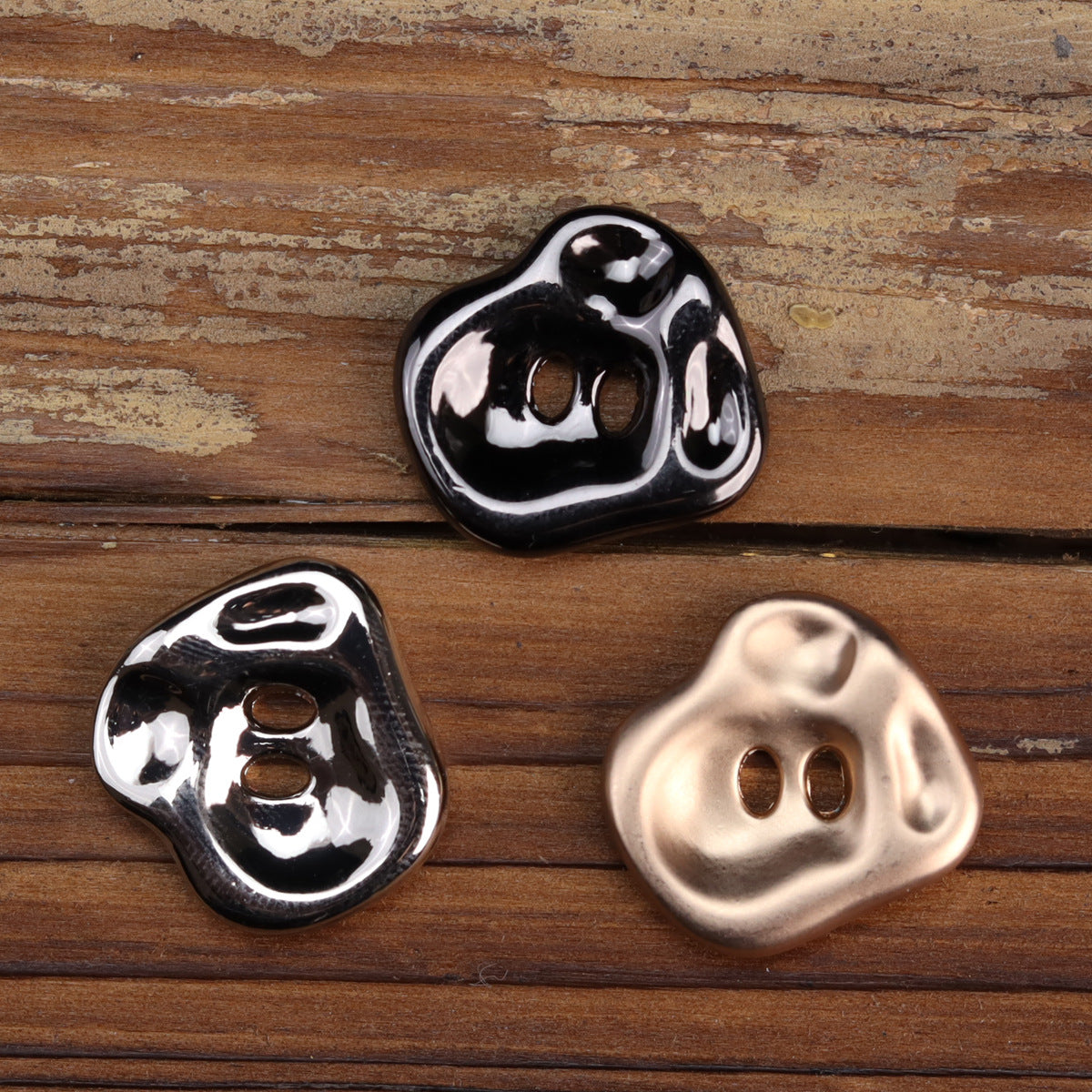 Irregular black and rose gold two-hole metal buttons, glossy finish