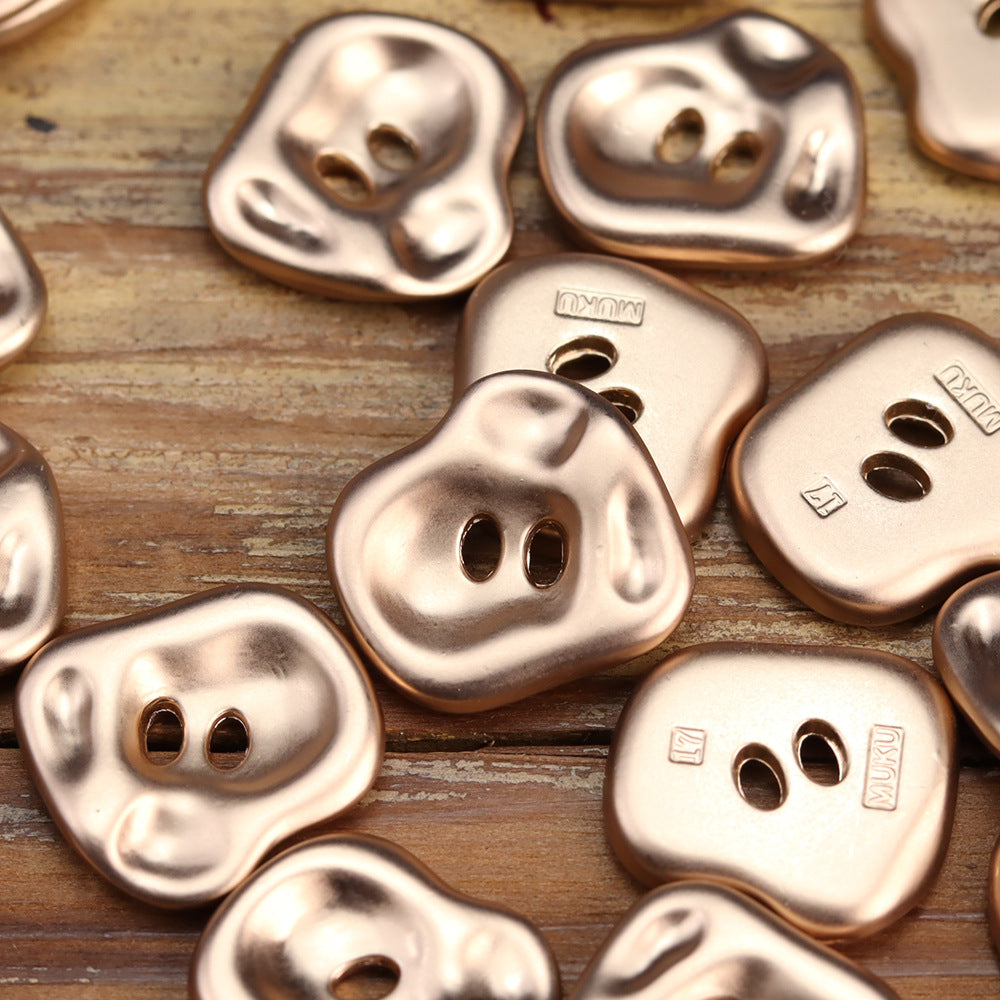 Set of irregular rose gold two-hole metal buttons with engraved logo