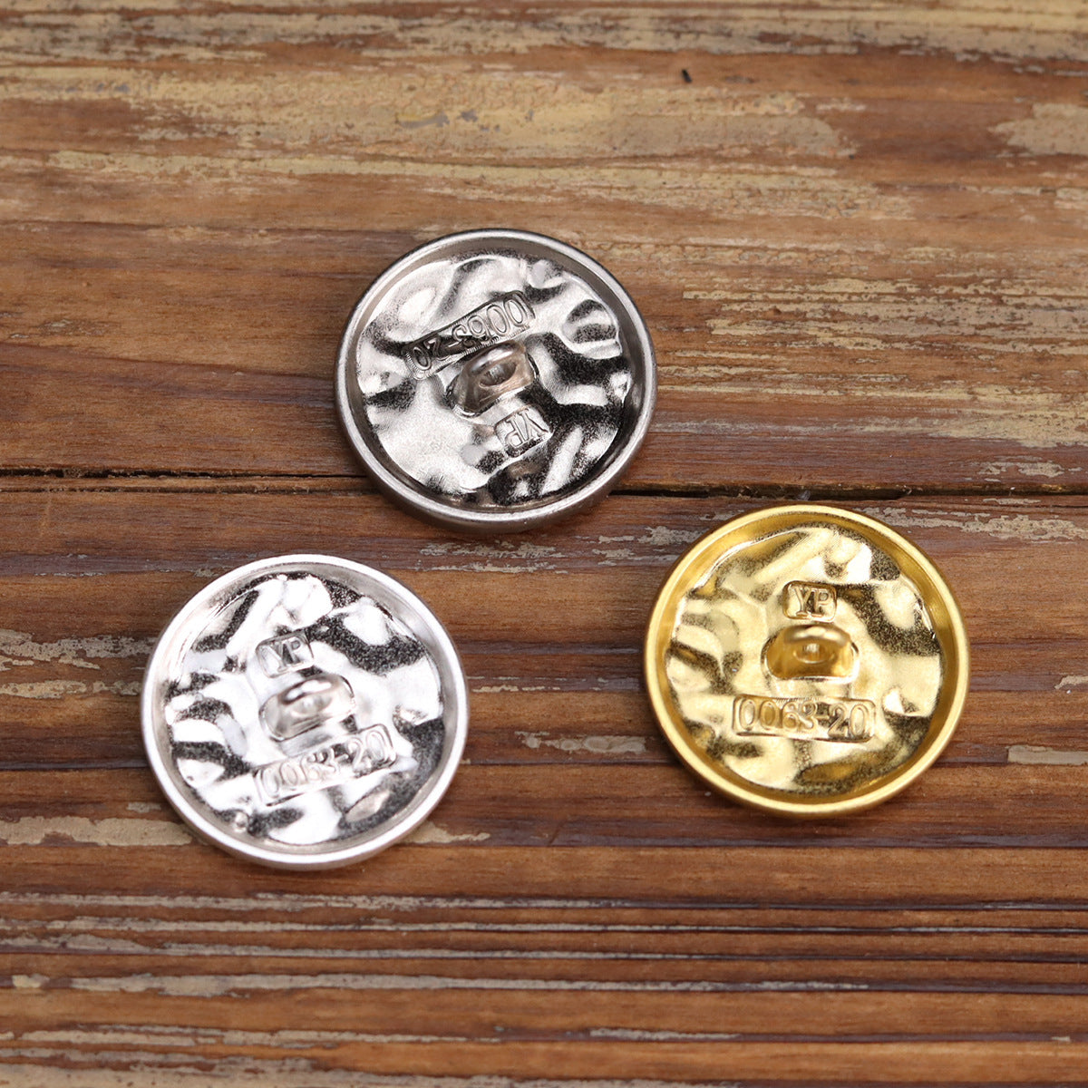 Round metal buttons with wavy embossed pattern, silver and gold finishes