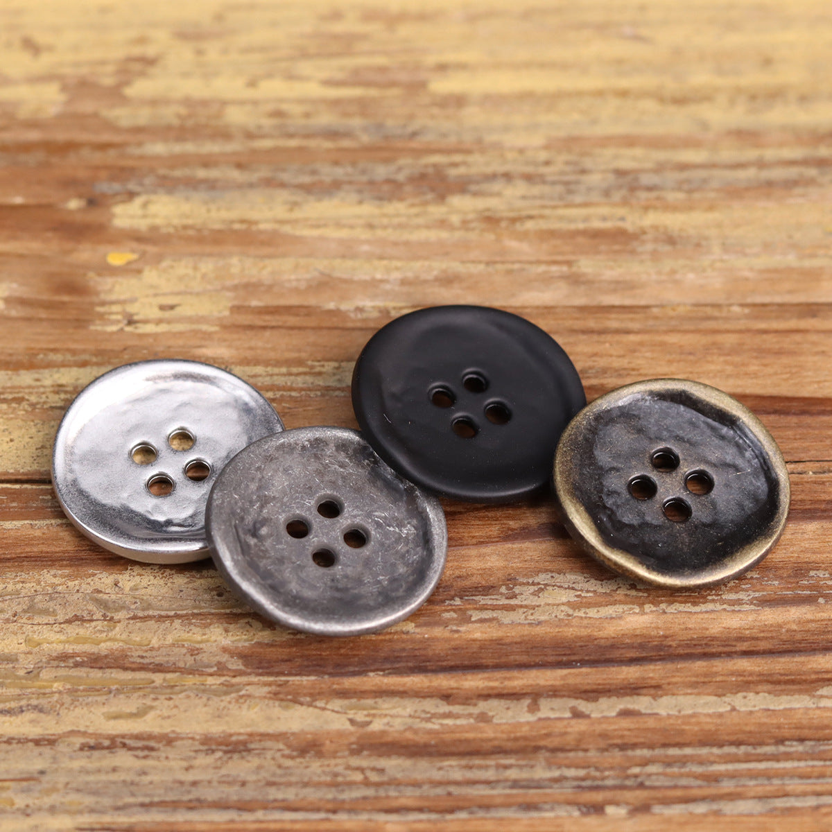 Assorted 4-hole metal buttons: silver, antique silver, black, and antique bronze