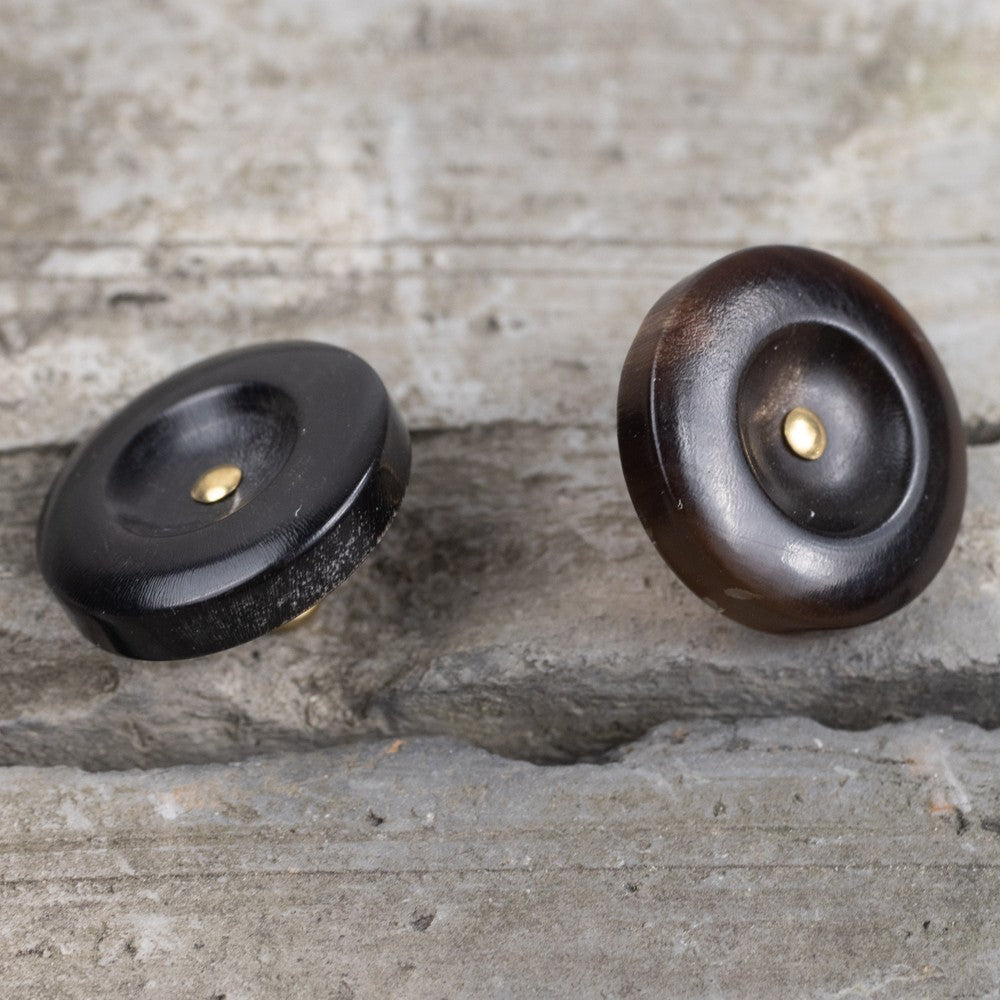 Dark horn shank button pair with brass centers on wide rims