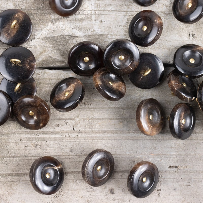 Assorted horn shank buttons in black and deep coffee tones with brass posts
