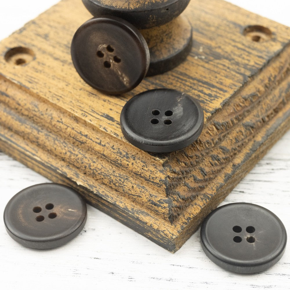 Matte black four-hole horn-style buttons, four button spread