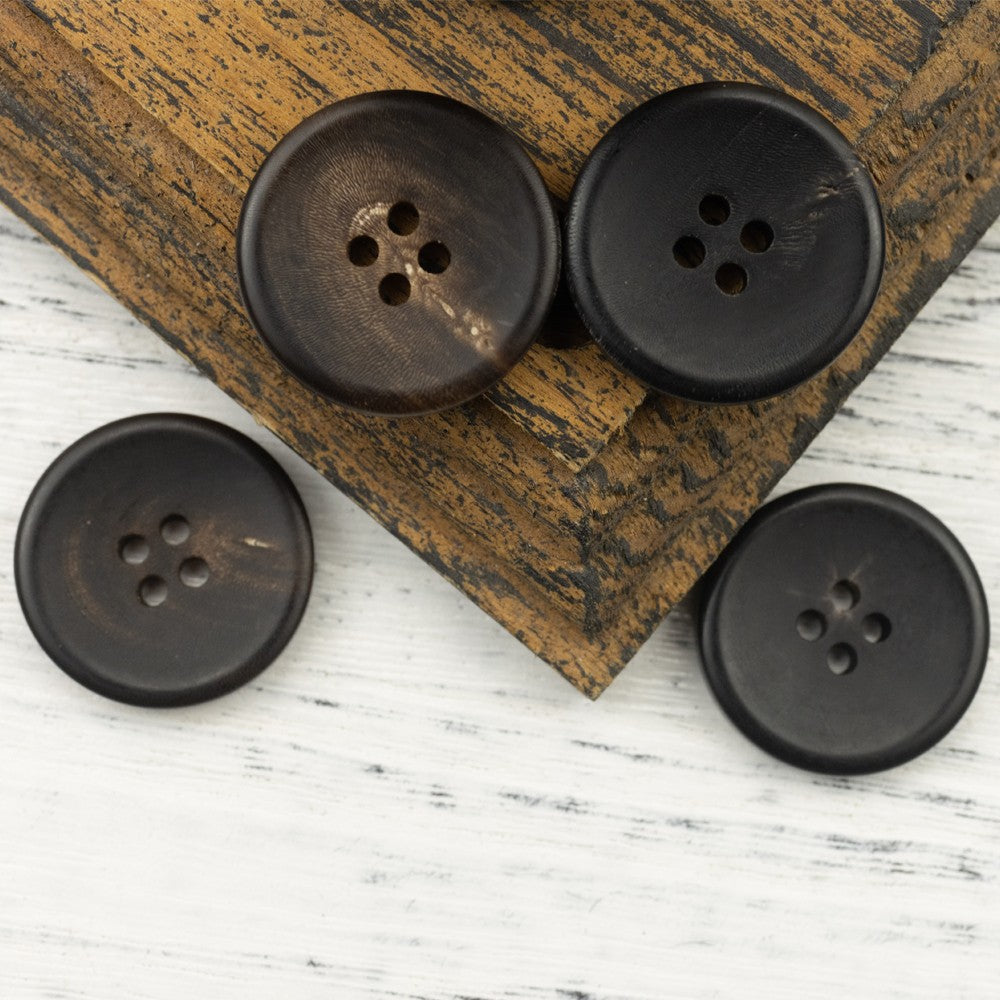 Matte black four-hole horn-style buttons, four-pack display