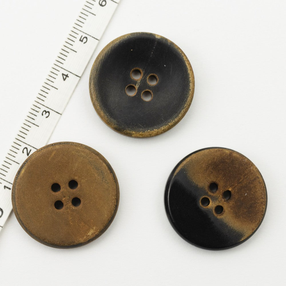 Three flat retro horn buttons, black, dark tan and burnt brown, four holes each