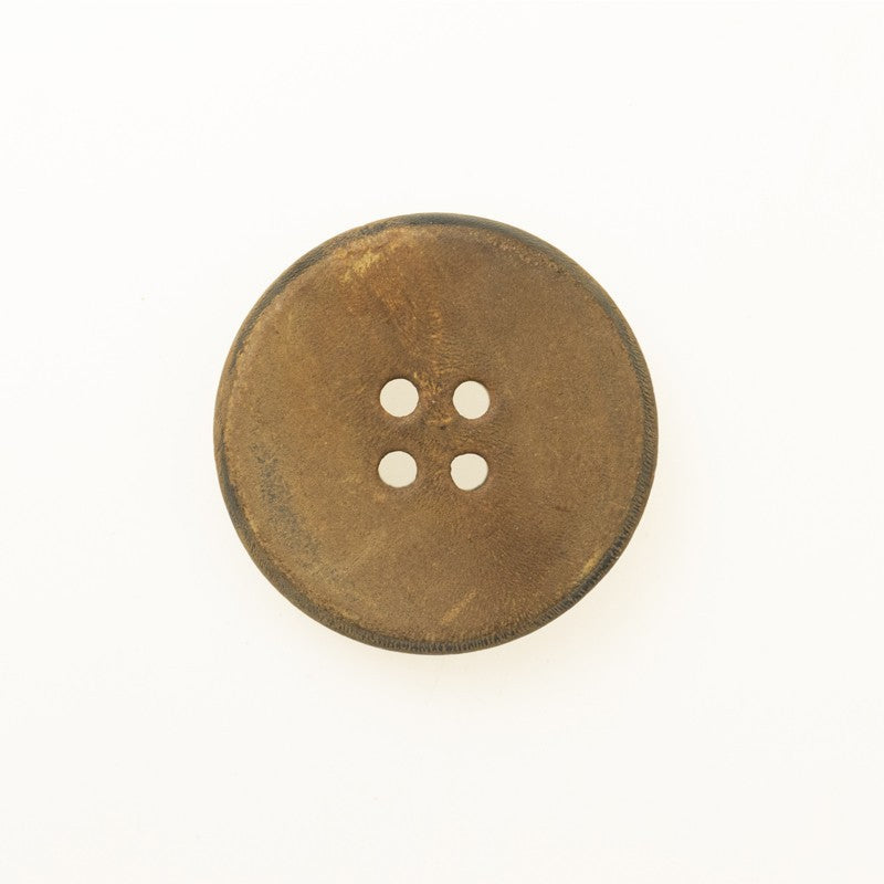 Yellowish-brown flat retro horn button with burnt half finish, four-hole front