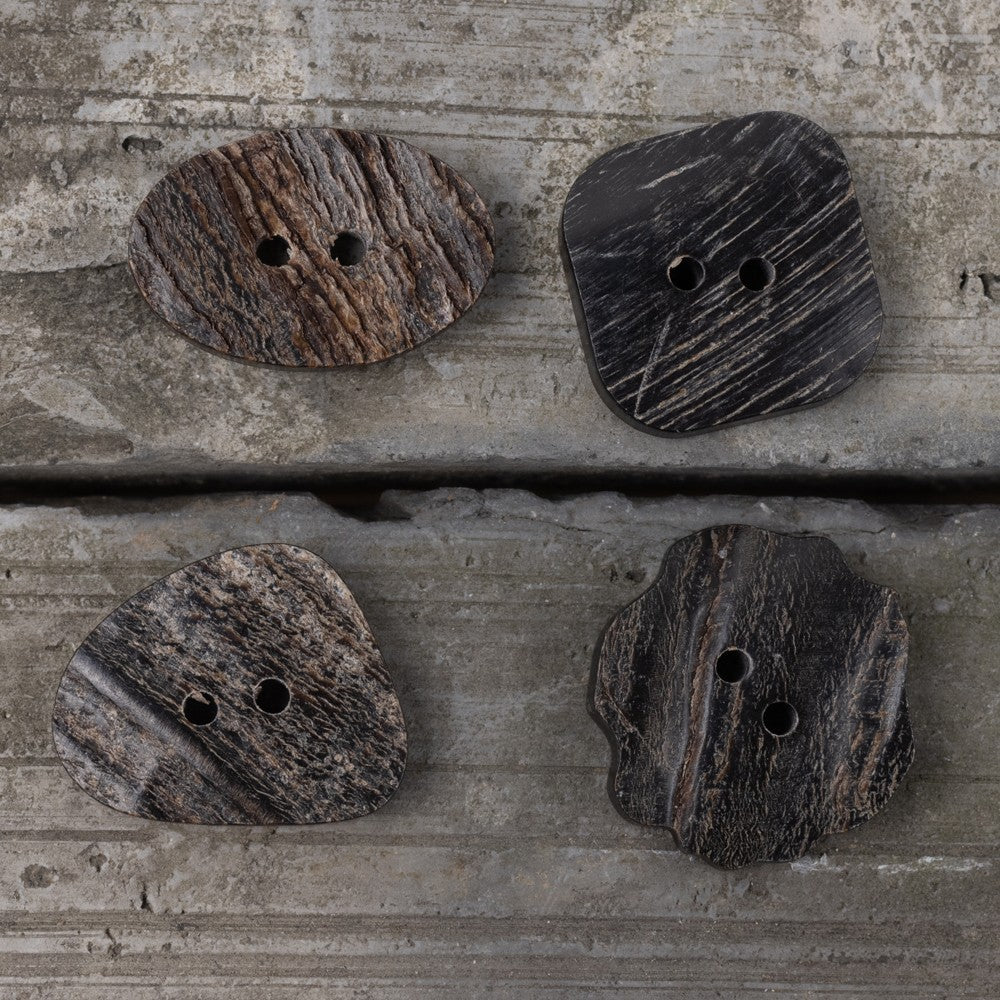 Black horn buttons with two holes in oval, triangle, square, and flower shapes