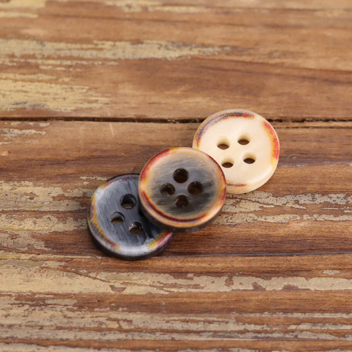 Resin shirt buttons with fire-burned edges, cream and smoky gray, four-hole bowl silhouette