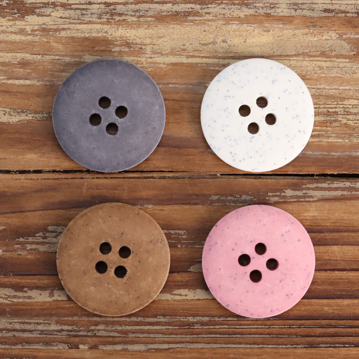 4-pack view: dark gray, white, coffee, and pink distressed stone buttons, each with 4 holes