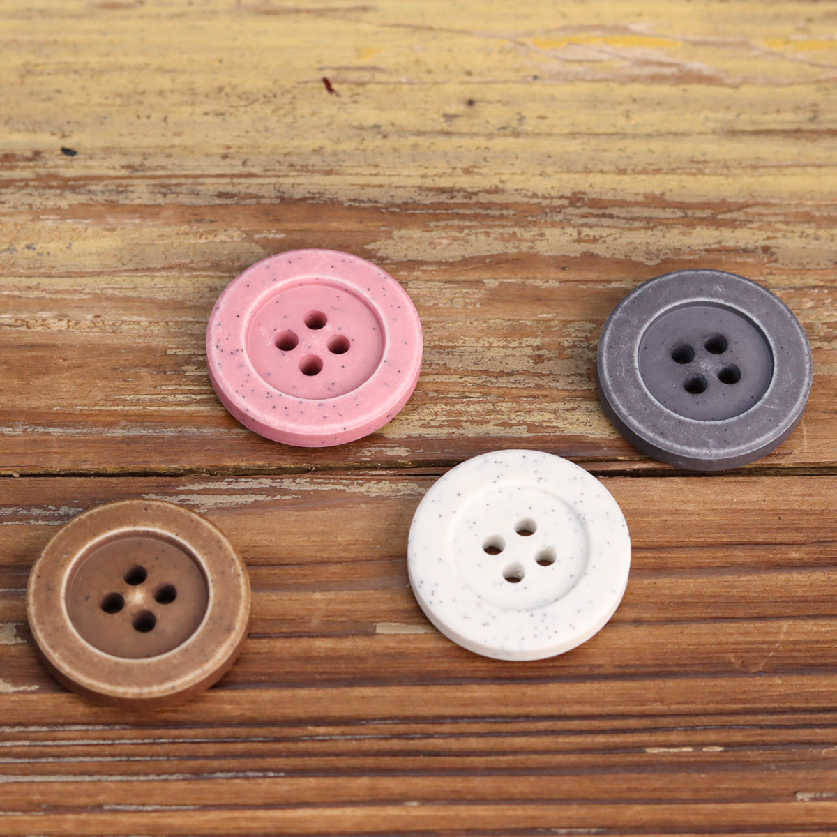 Set of 4 distressed stone buttons: pink, dark gray, white, and coffee, each with 4 holes