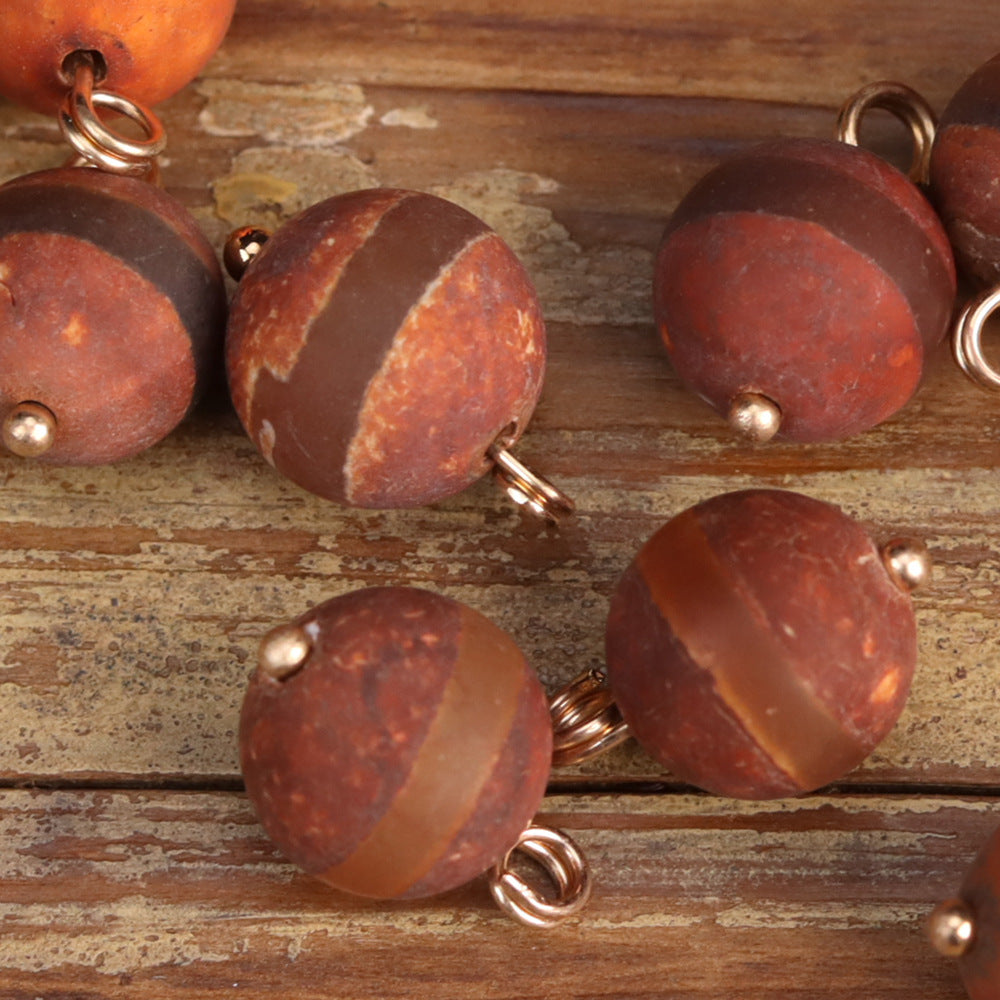 Agate stone button beads with metal loops in reddish-brown and amber tones