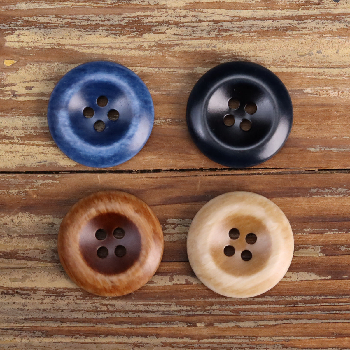 Four 4-hole resin double-sided buttons: blue, black, tan (khaki), dark coffee brown.