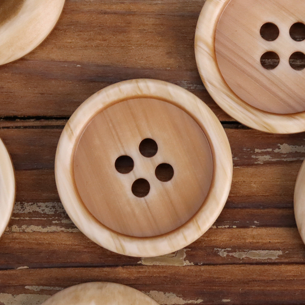 Khaki resin double-sided button, 4 holes, round with smooth rim.