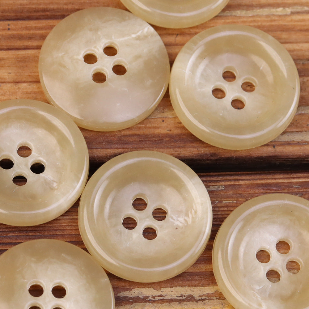 Light beige 4-hole round urea jacket buttons with imitation horn texture sheen