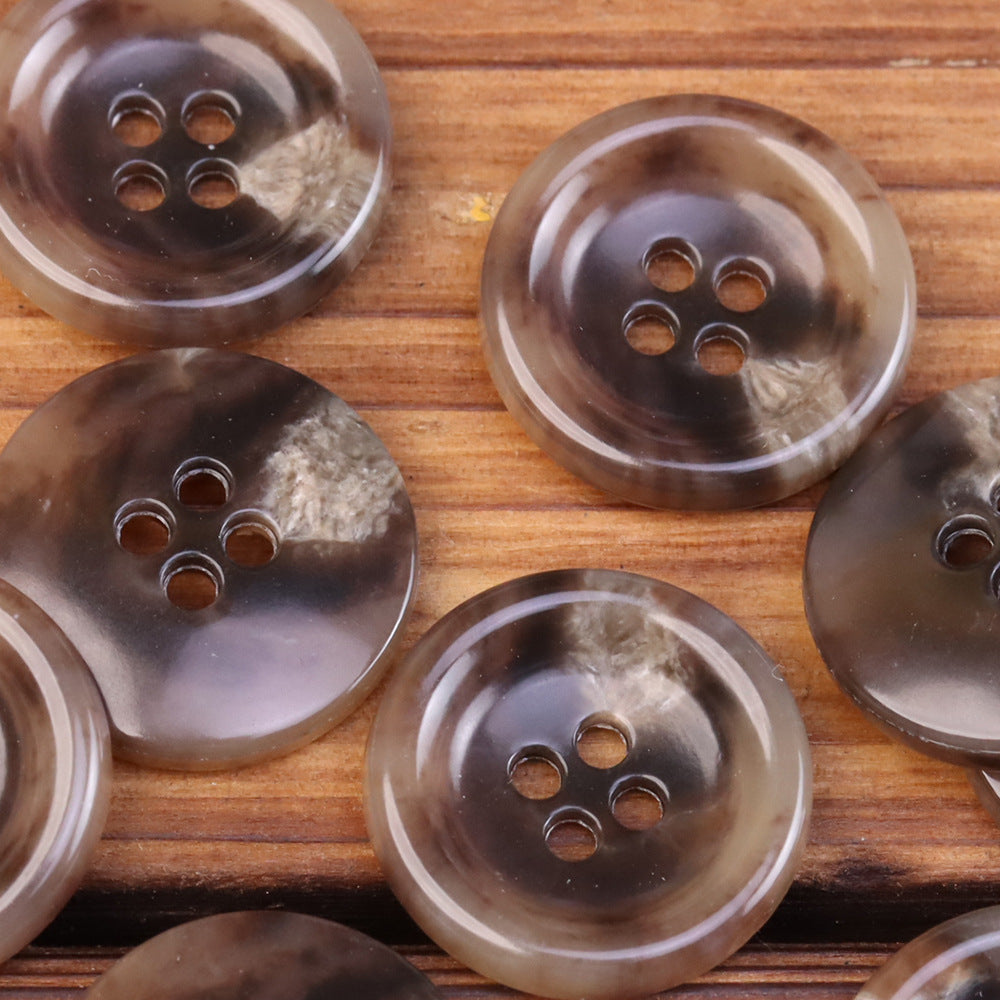Dark brown and translucent 4-hole round urea jacket buttons with horn-like texture