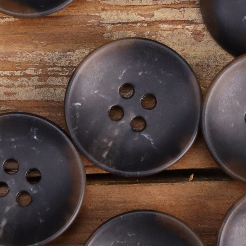 Dark navy 4-hole buttons, bowl-shaped, close-up view with slight surface specks