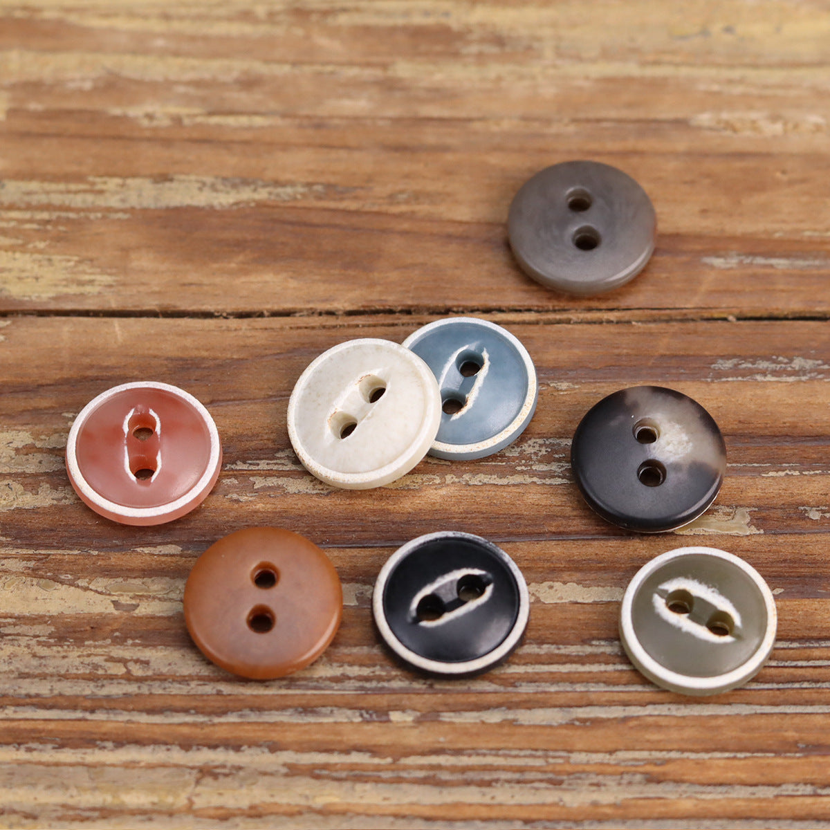 Burned urea buttons for cardigans, round two-hole styles in muted red, blue, brown, black