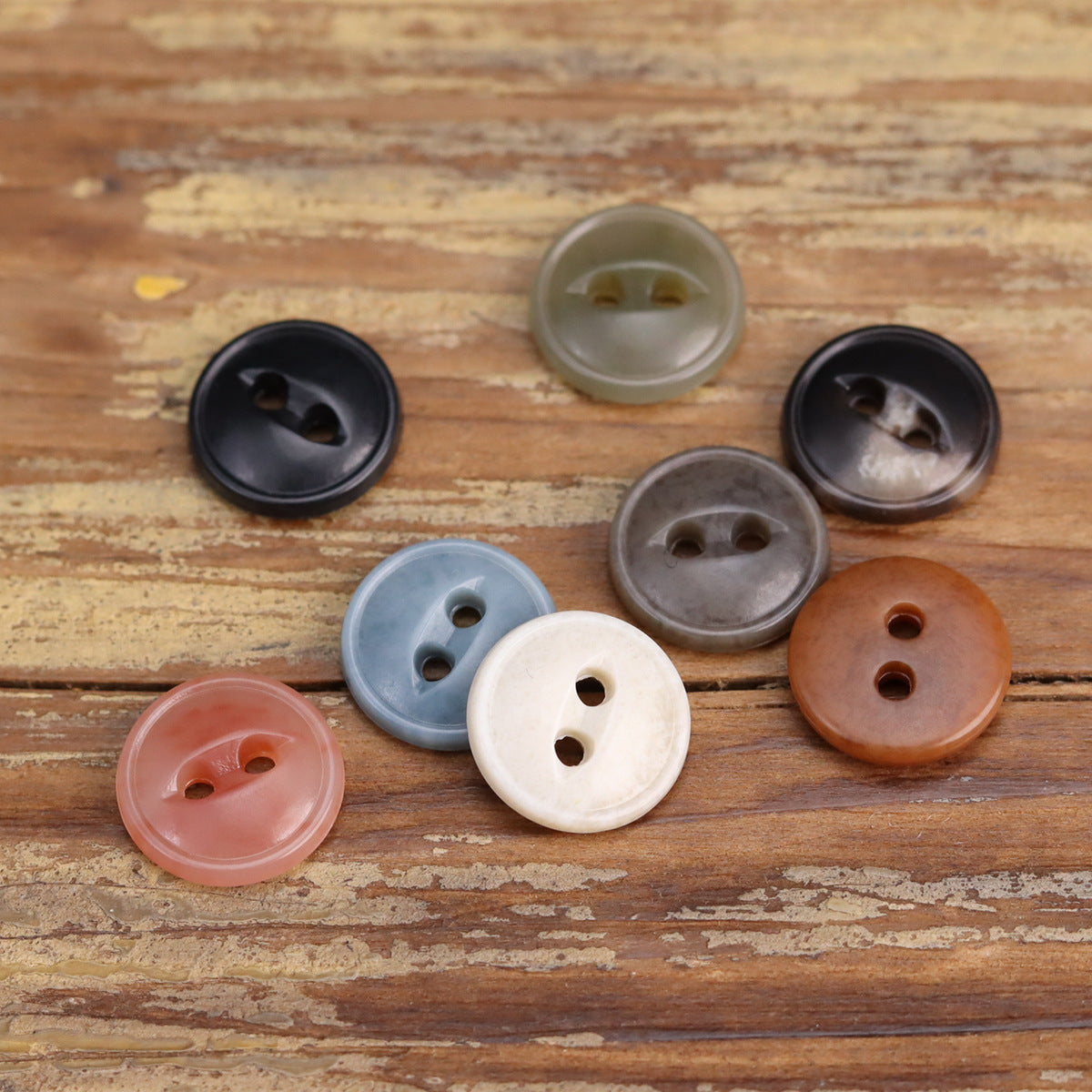 Assorted two-eye urea buttons, round 2-hole design in blue, white, orange, pink